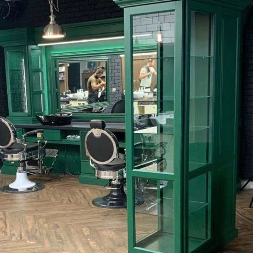 Zelené vitríny a barberské kreslá